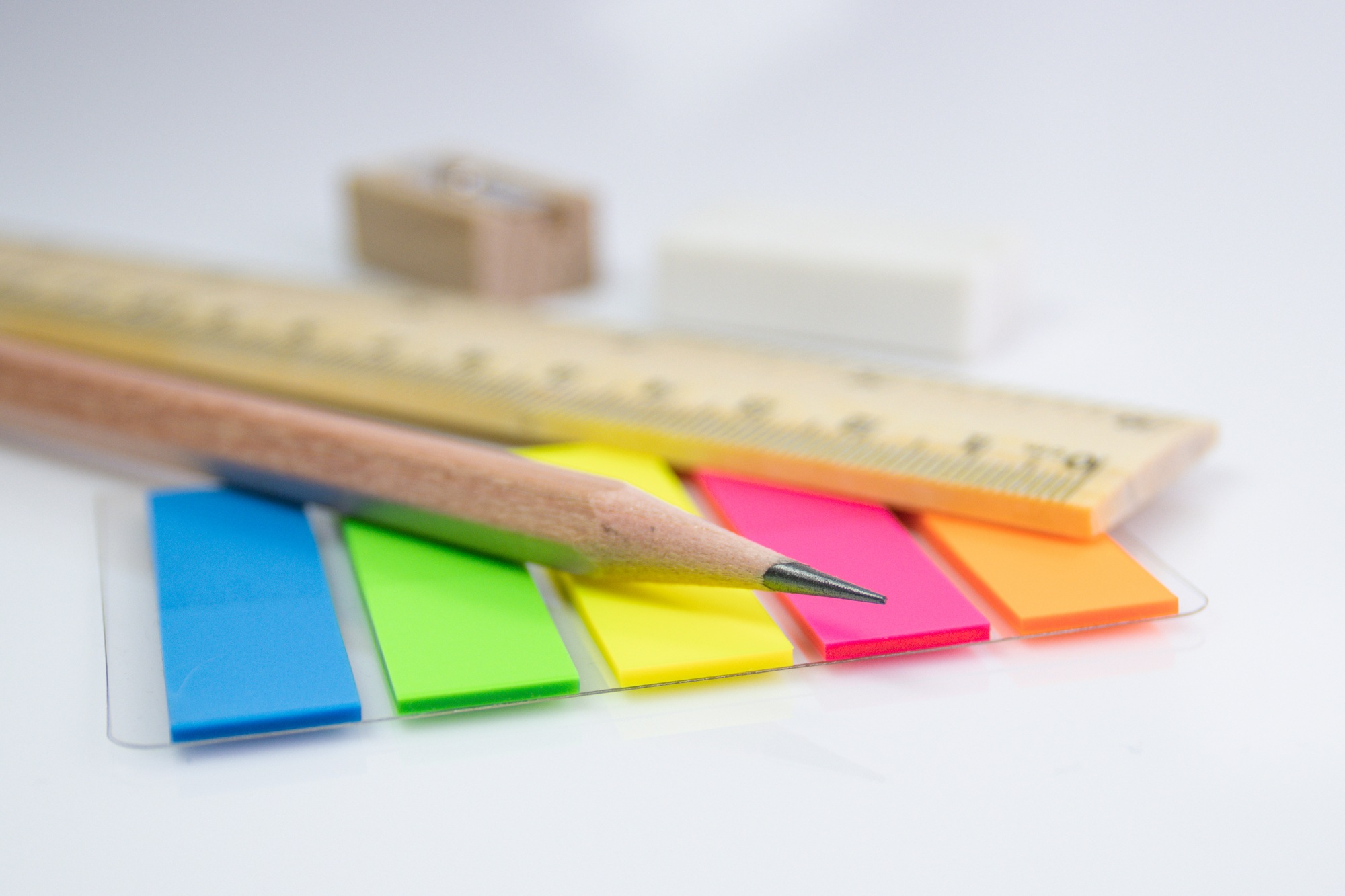 close up a pencil with paper color note on white background